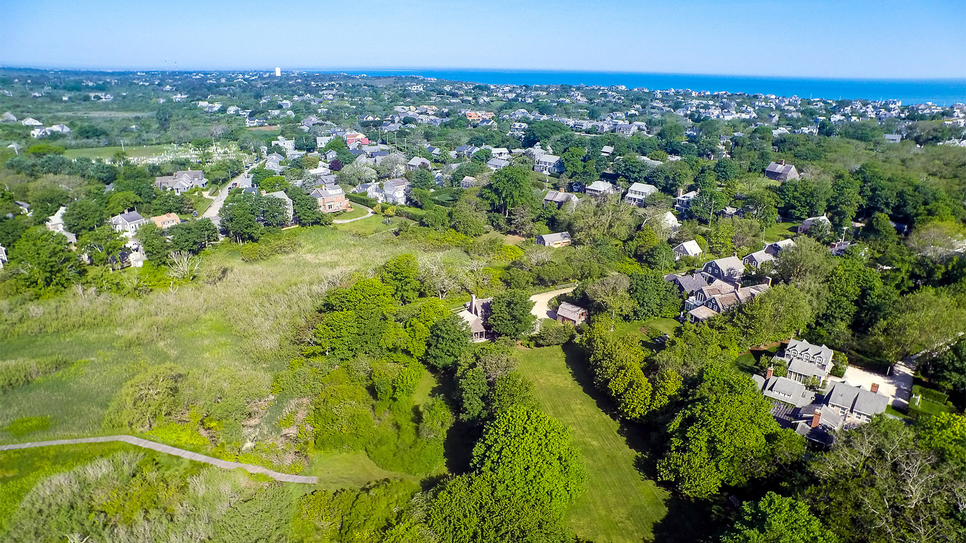Aerial view across 6 Wesco Place, Lily Pond, Nantucket town, and the water beyond
